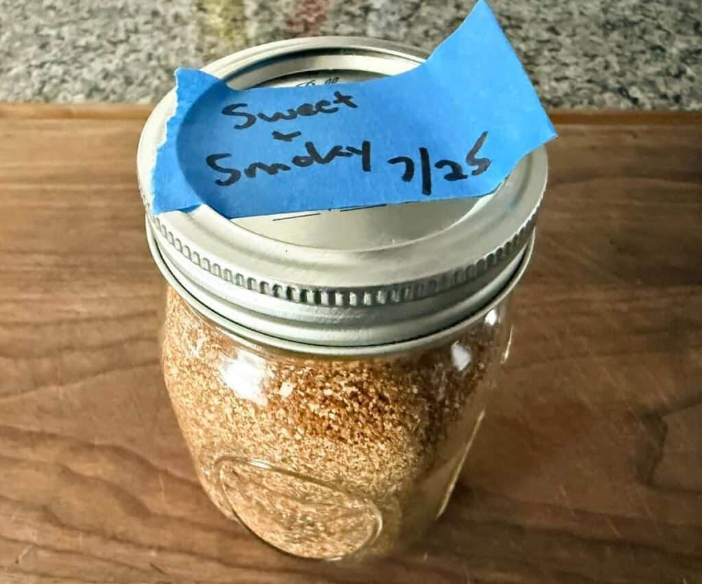 A jar full of homemade sweet and smoky rub