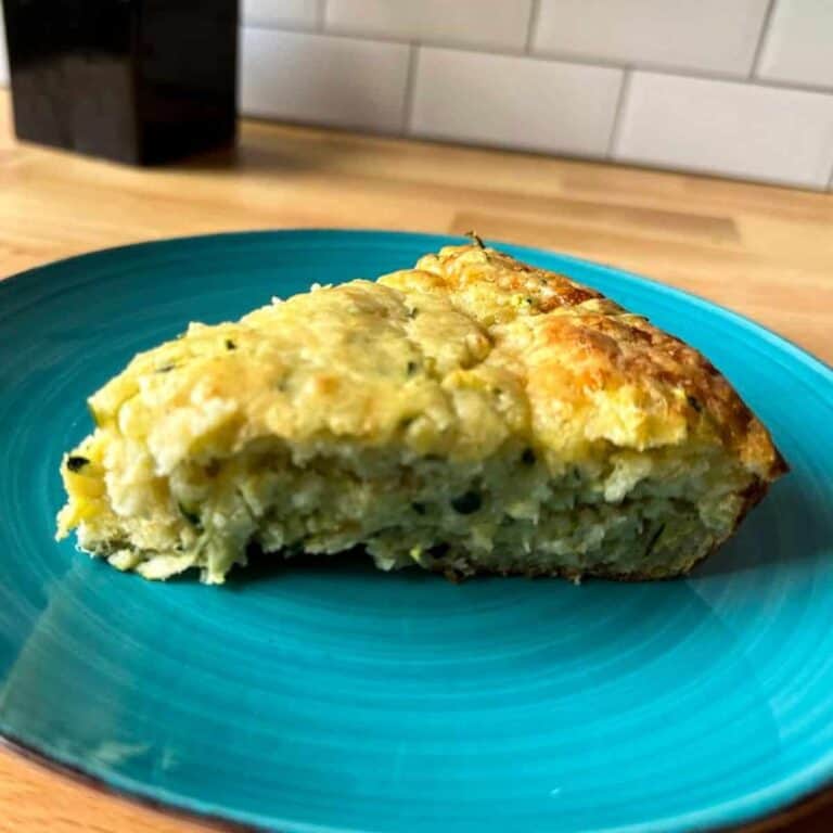 Slice of zucchini pie on a blue plate