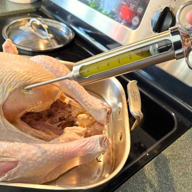 Injecting a turkey with my recipe including butter, garlic, and herbs