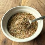 Dry turkey rub seasoning in a small white bowl with a silver spoon