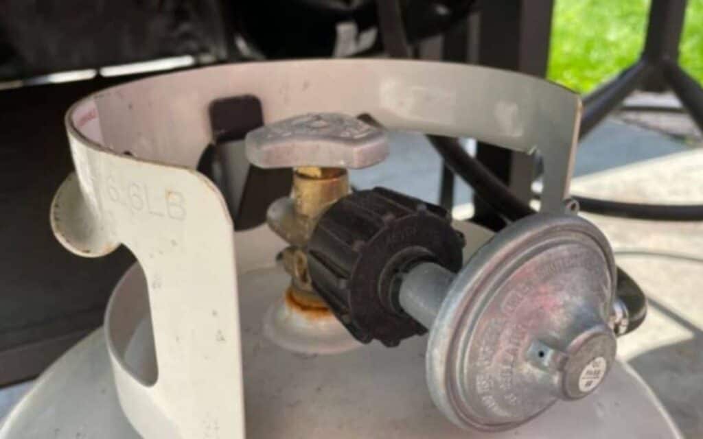 Close up of a propane tank and regulator