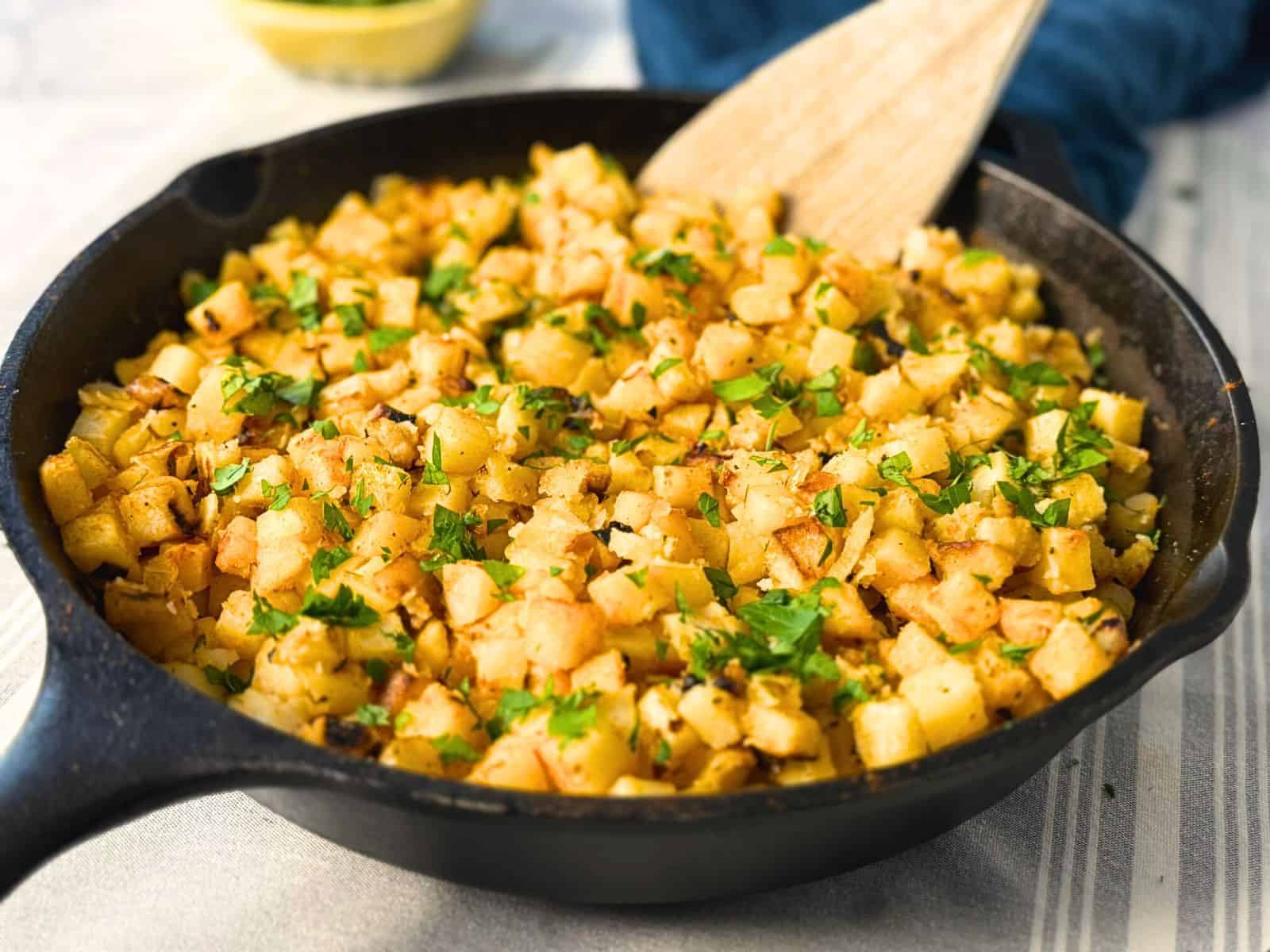 Cast iron pan full of crispy breakfast potatoes