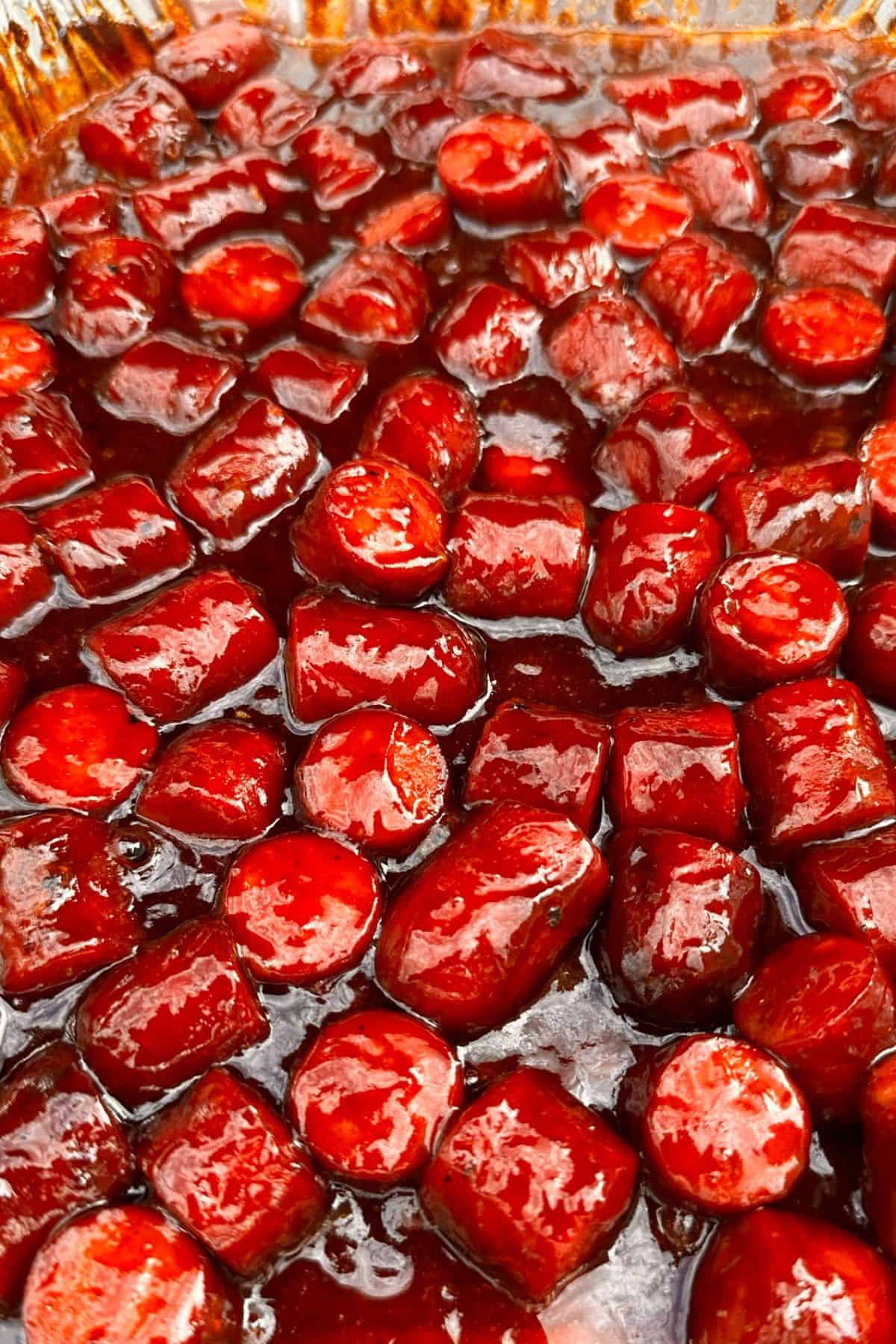 Tray of hot dog burnt ends covered in sweet BBQ sauce